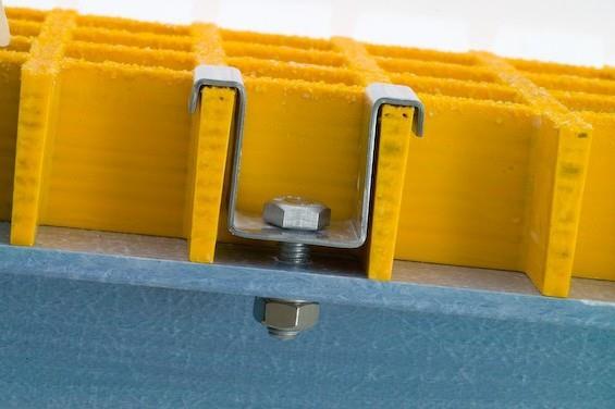 Section through grating showing a hold-down clip and support.